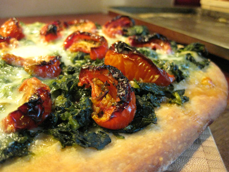 Spinach, sun-dried tomato, and mozzarella pizza